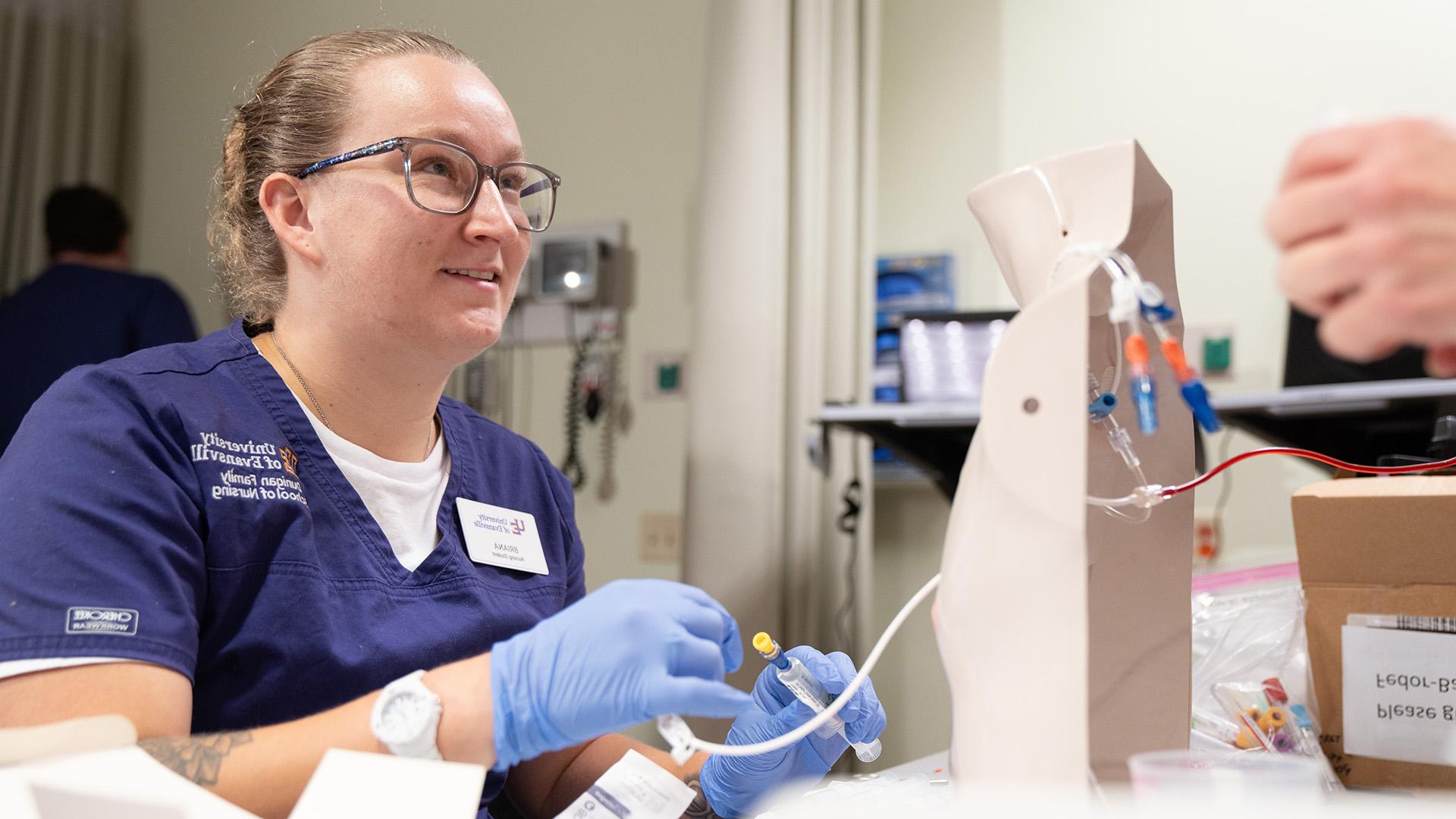 ABSN student smiling in lab